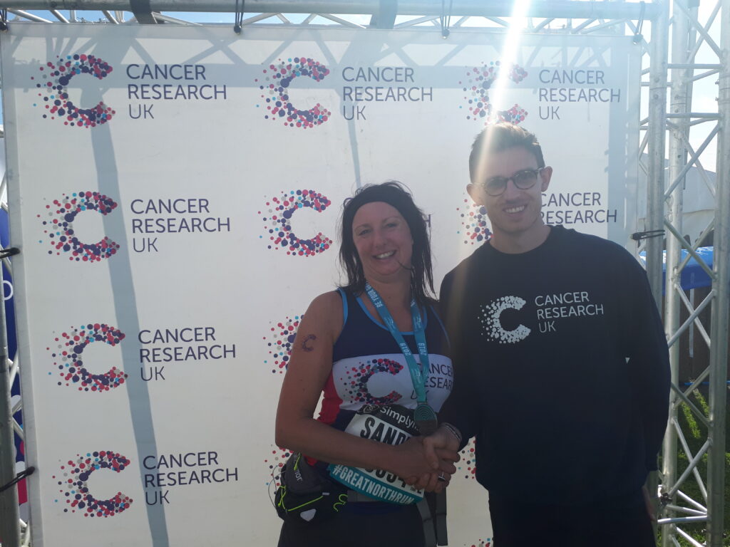 Sandra Cowham with a representative from Cancer Research UK after completing The Great North Run. 
