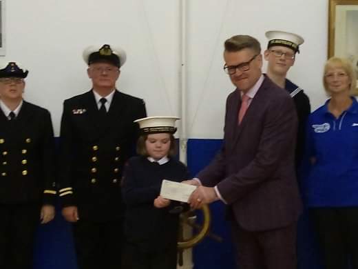Robert Abbott Store Manager at Pavers Brighton, handing the donation cheque over to T.S Nautilus. 